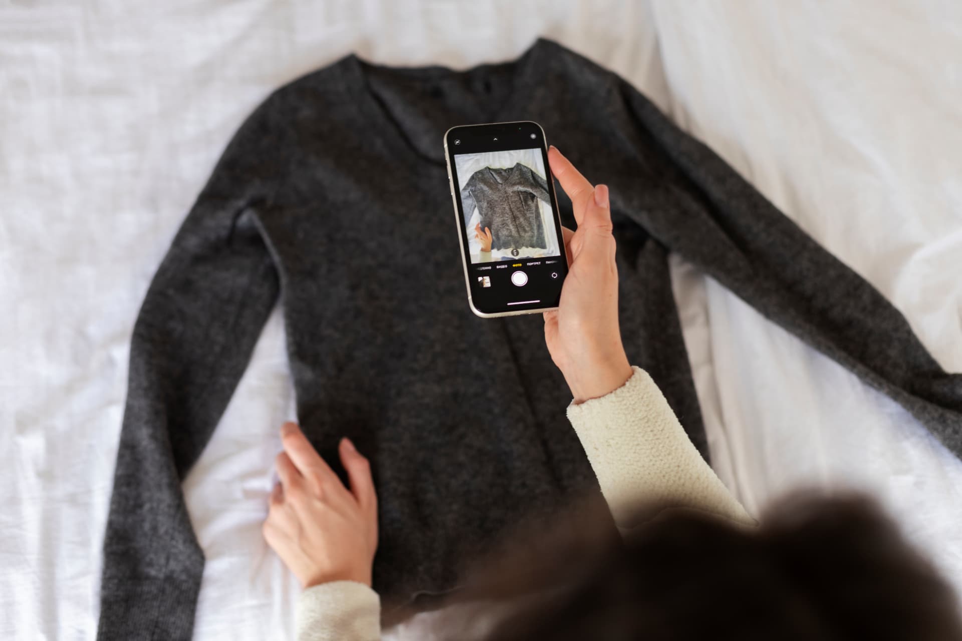 A seller photographing a jacket for a marketplace listing